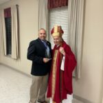 Grand Knight Paul Reeb presenting a plaque to the Archbishop